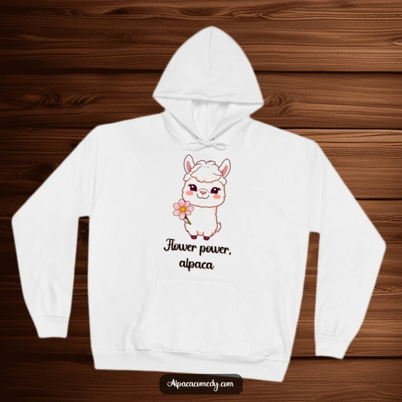 Funny hoodie showing a winking alpaca character offering a bloom with a gentle smile, perfect for cozy, heartwarming days.