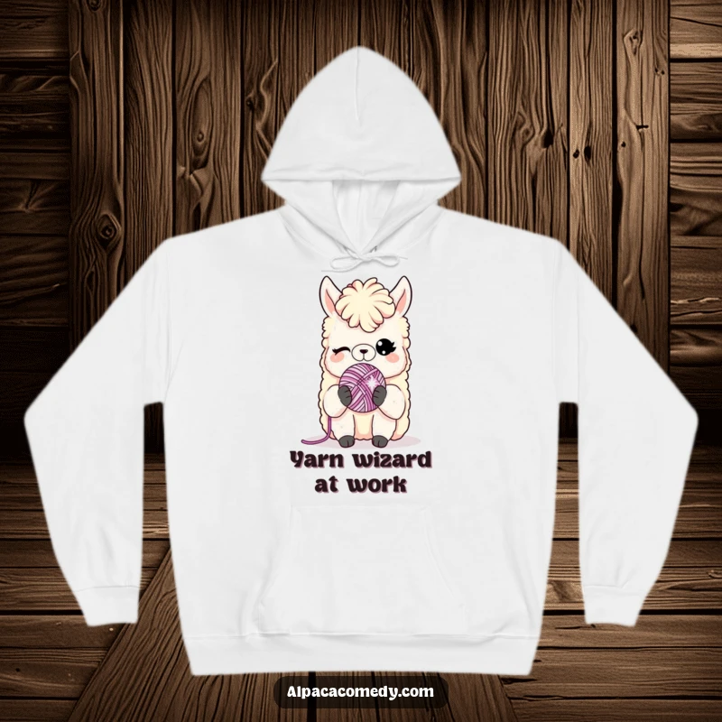 Funny hoodie: A charming alpaca winks holding a tiny, sparkling yarn ball, perfect for cozying up with a playful vibe.