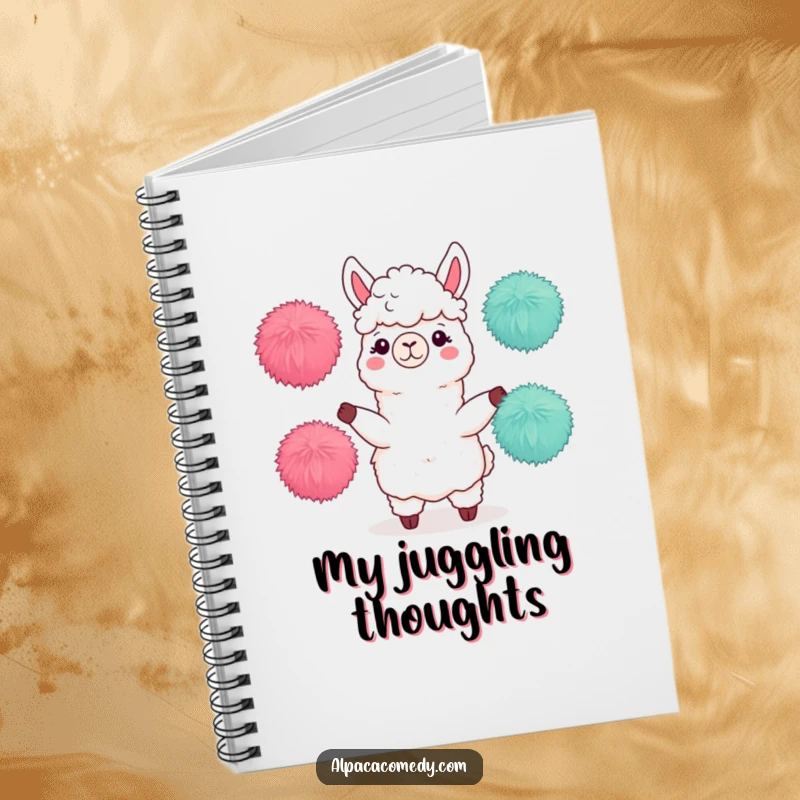 Funny notebook displaying an alpaca character skillfully juggling three fuzzy pom-poms, a symbol of organization and playful talent.