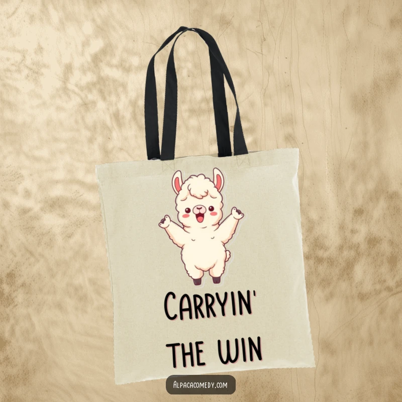 Funny tote bag featuring an alpaca character cheering triumphantly with both front legs raised, perfect for carrying fan gear.